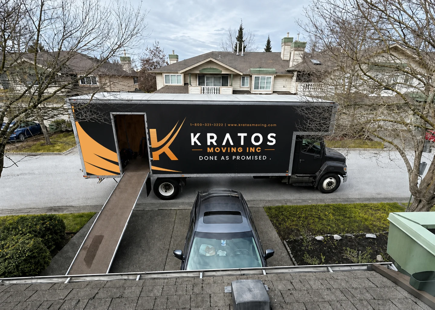 A Kratos moving truck parked on a residential street